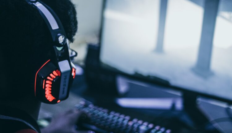 person wearing orange and black headphones